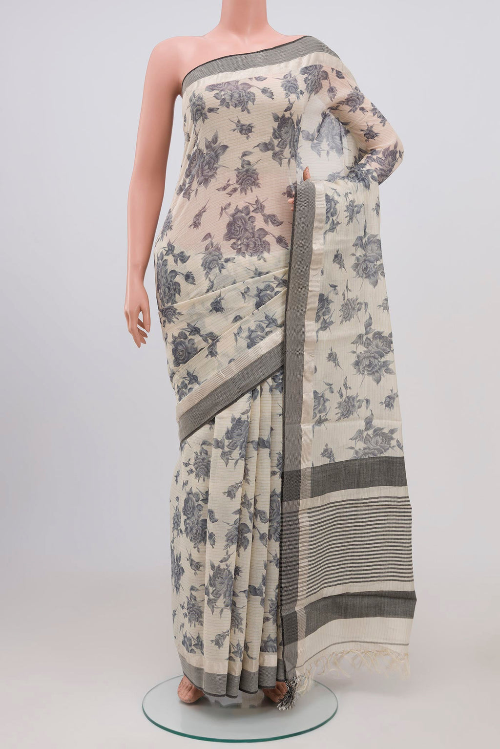 Beige Tussar Saree with Floral Print on the body and Zari Border.  displayed on a mannequin