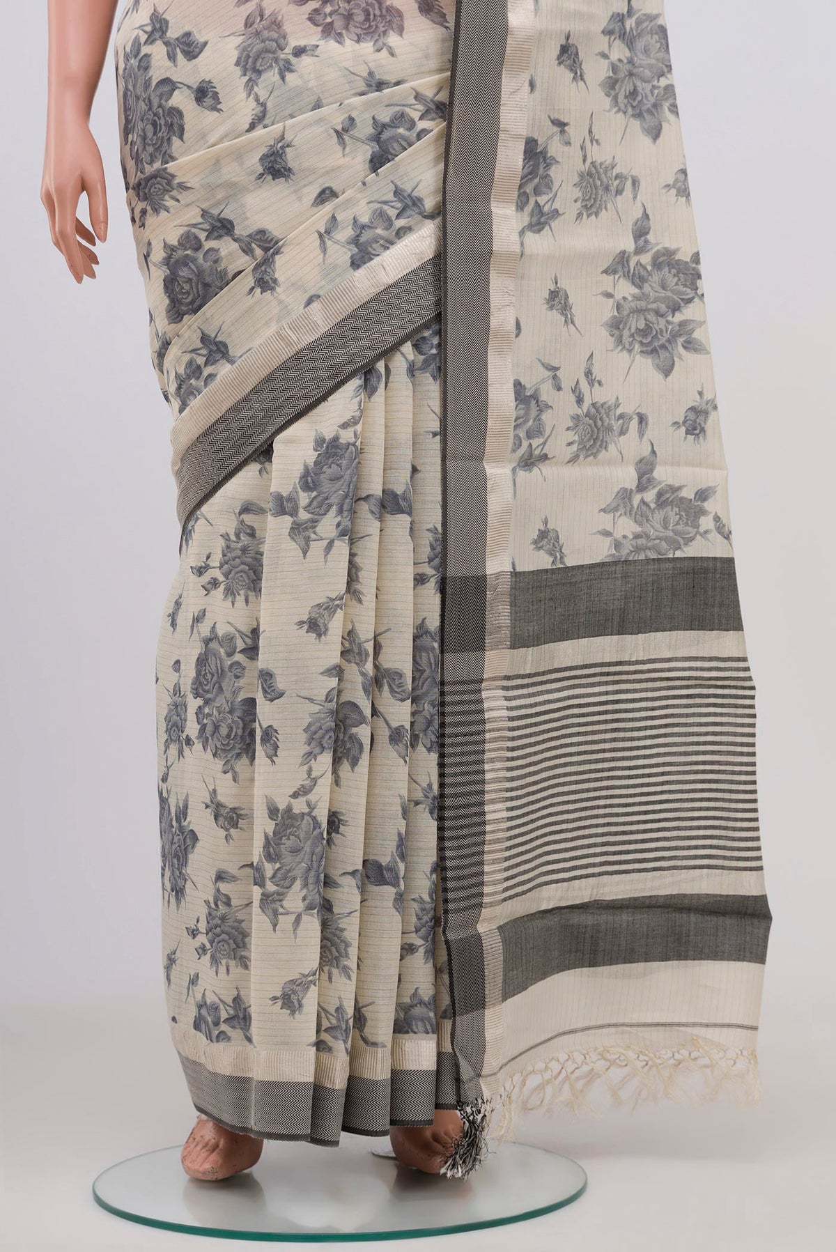 Pleats and pallu of Beige Tussar Saree with Floral Print on the body and Zari Border. 
