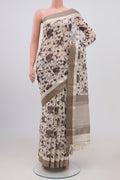 Off White Tussar Saree with Floral Print on the body and Zari Border.  displayed on a mannequin