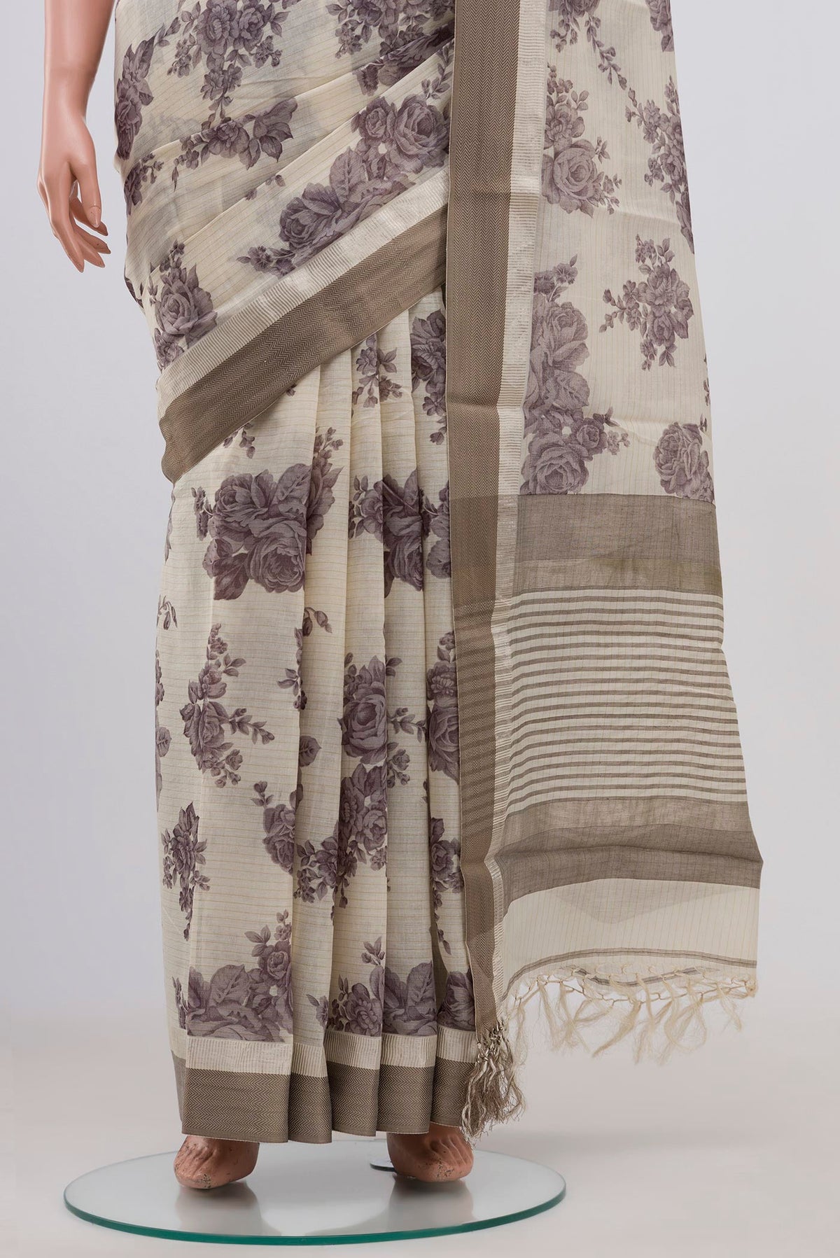 Pleats and pallu of Beige Tussar Saree with Floral Print on the body and Zari Border. 