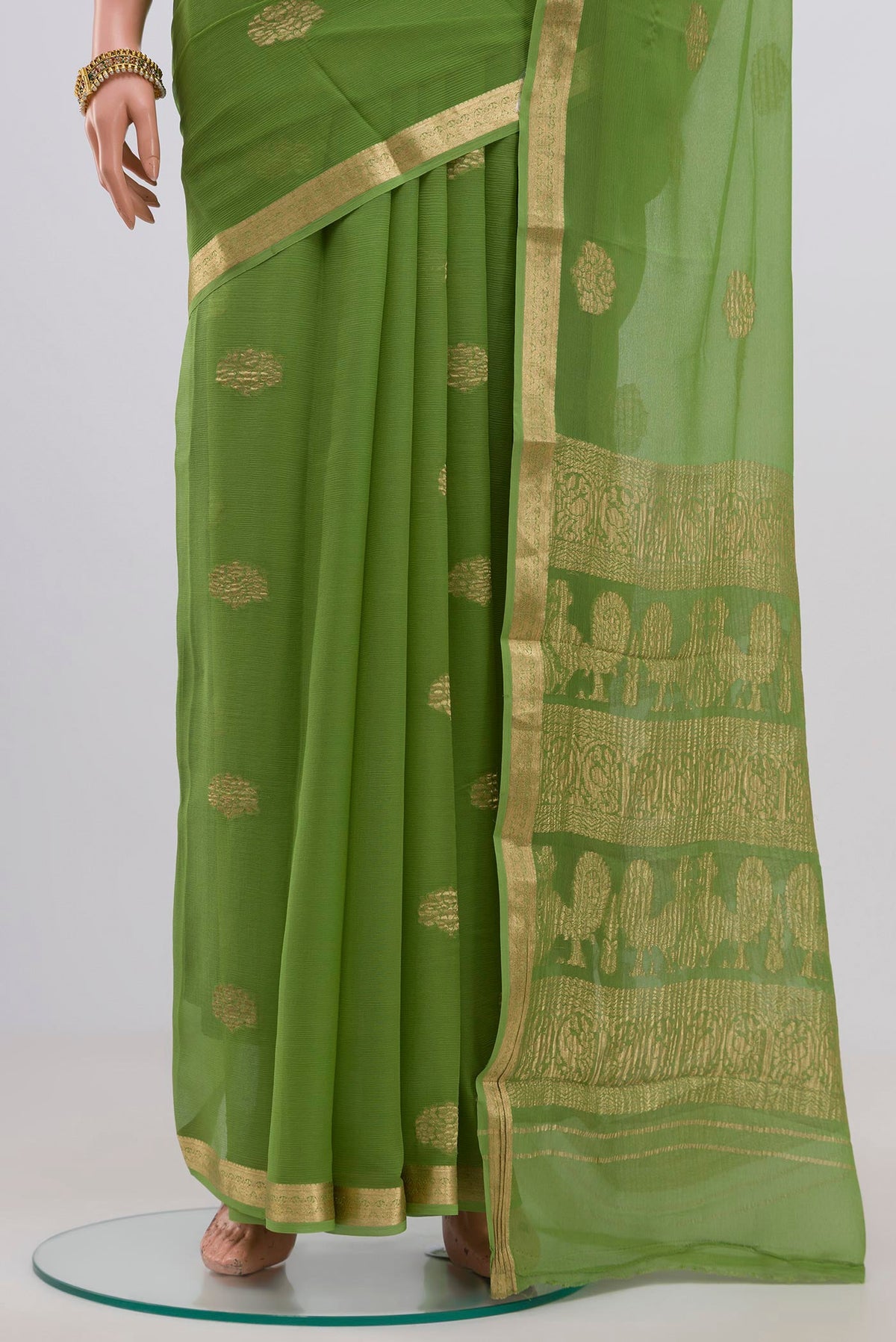 Pleats and pallu of Green Chiffon Saree with Zari Butta on the body and Zari Border. 