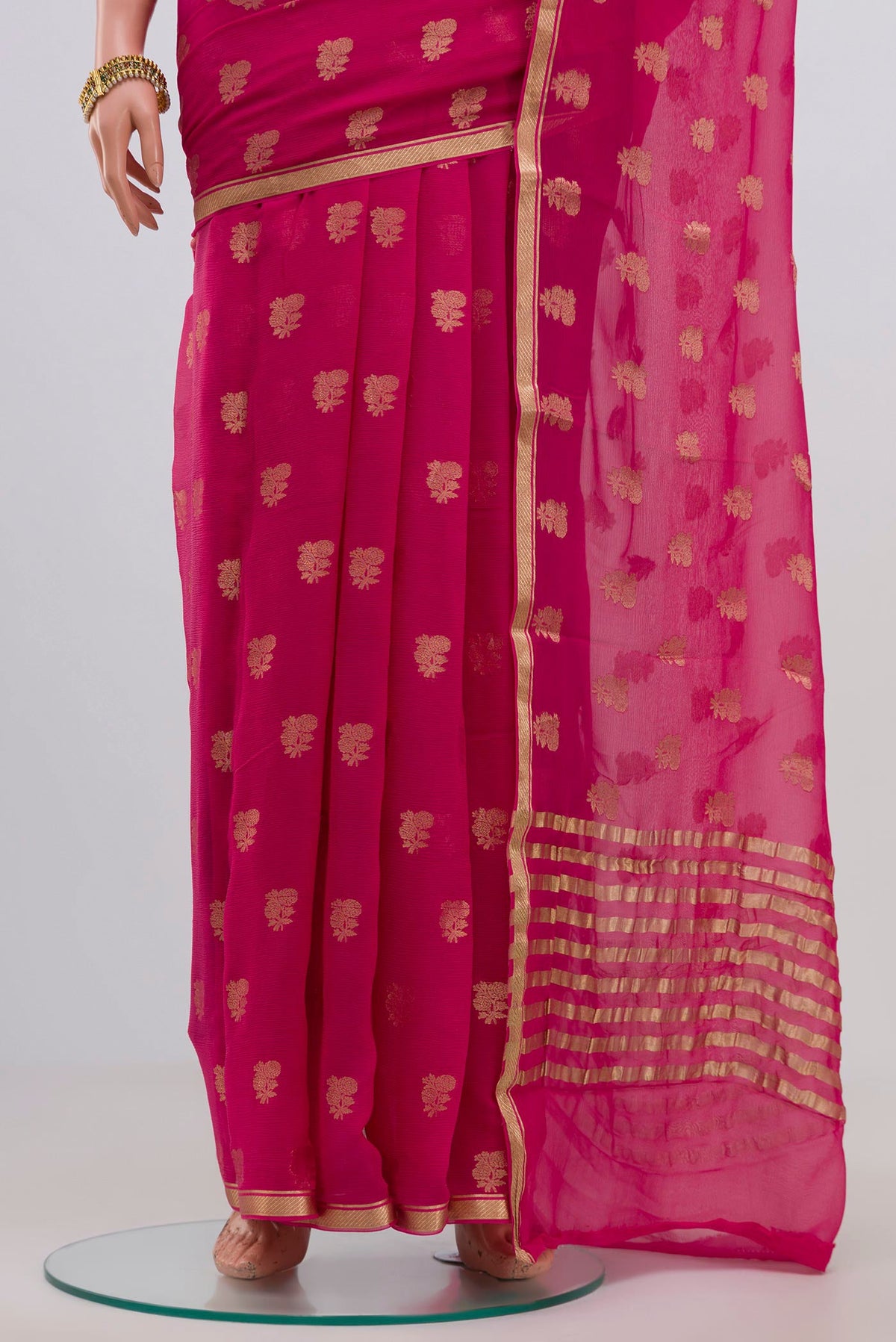 Pleats and pallu of Pink Chiffon Saree with Zari Butta on the body and Zari Border. 