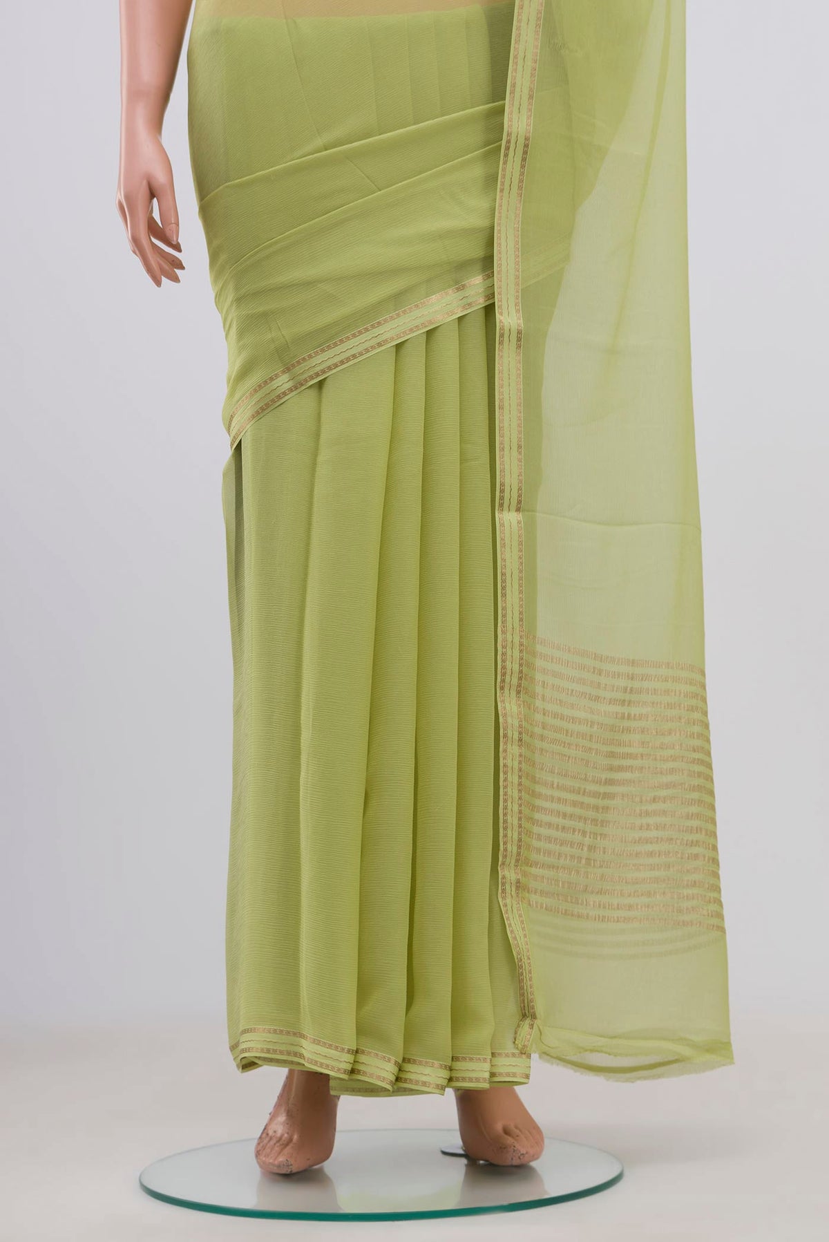 Pleats and pallu of Pista Green Chiffon Saree with Plain Body and Zari Border. 