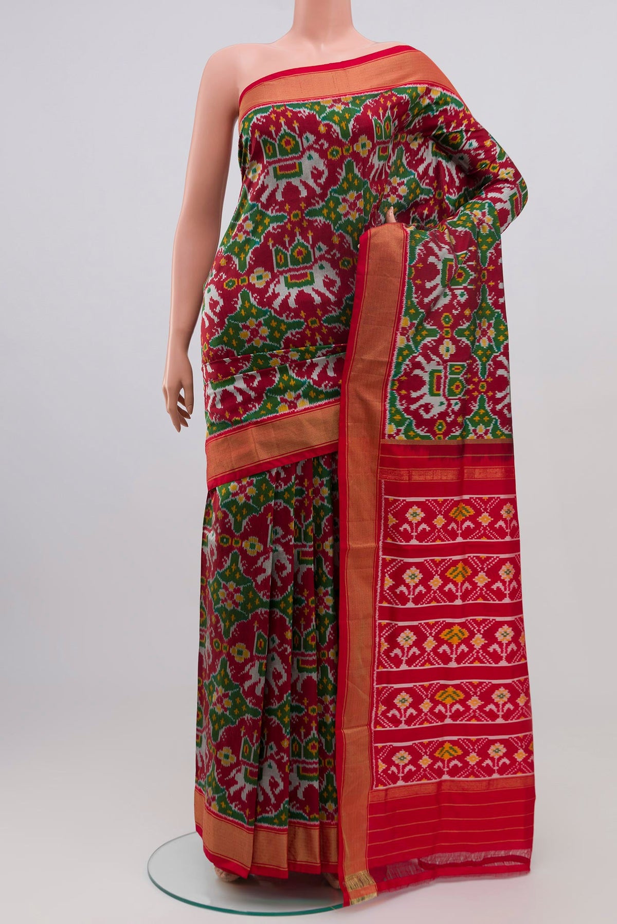 Maroon Pochampally Silk Saree with Ikat Print on the body and Zari Border.  displayed on a mannequin