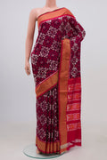 Brown Pochampally Silk Saree with Ikat Print on the body and Zari Border.  displayed on a mannequin