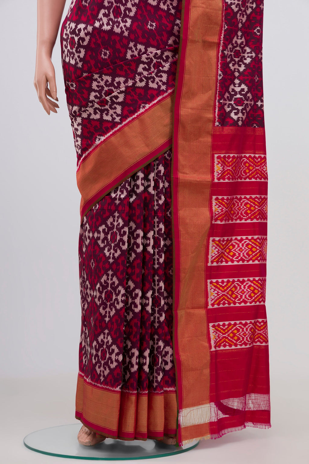 Pleats and pallu of Brown Pochampally Silk Saree with Ikat Print on the body and Zari Border. 