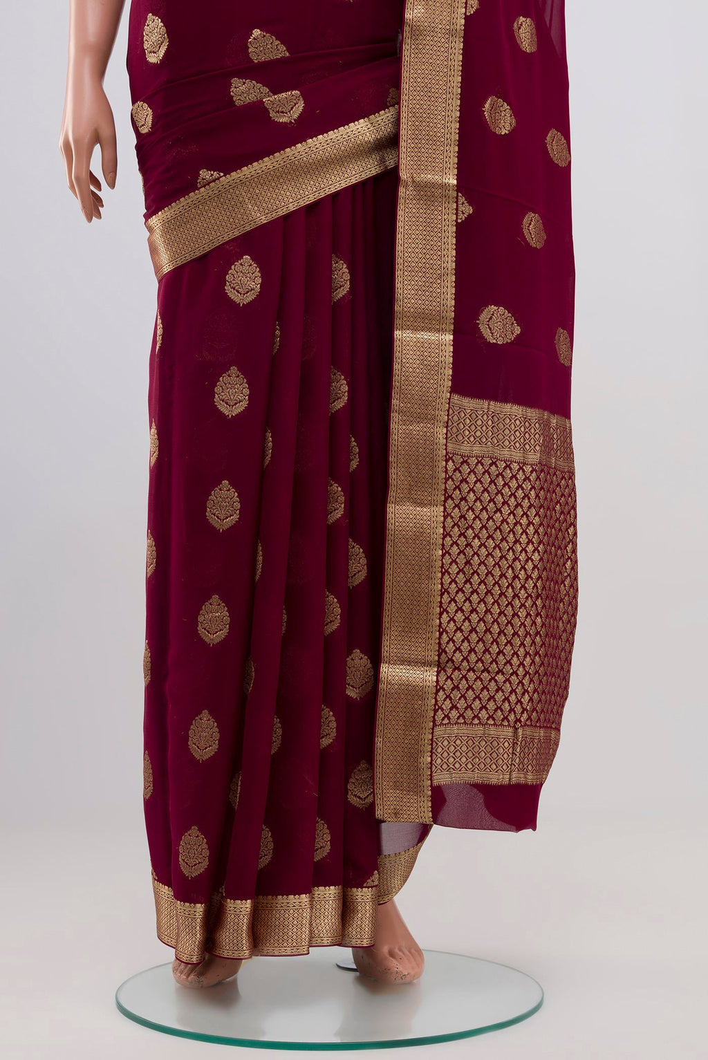 Pleats and pallu of Purple Georgette Saree with Zari Butta on the body and Zari Border. 