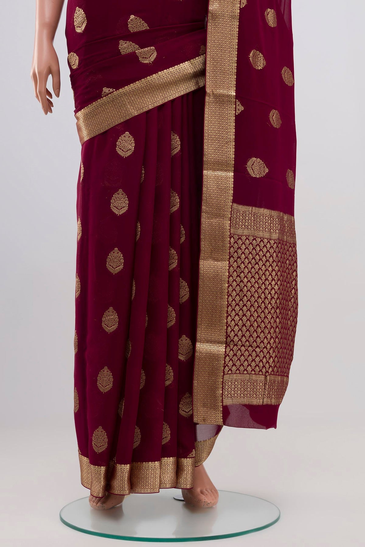Pleats and pallu of Purple Georgette Saree with Zari Butta on the body and Zari Border. 