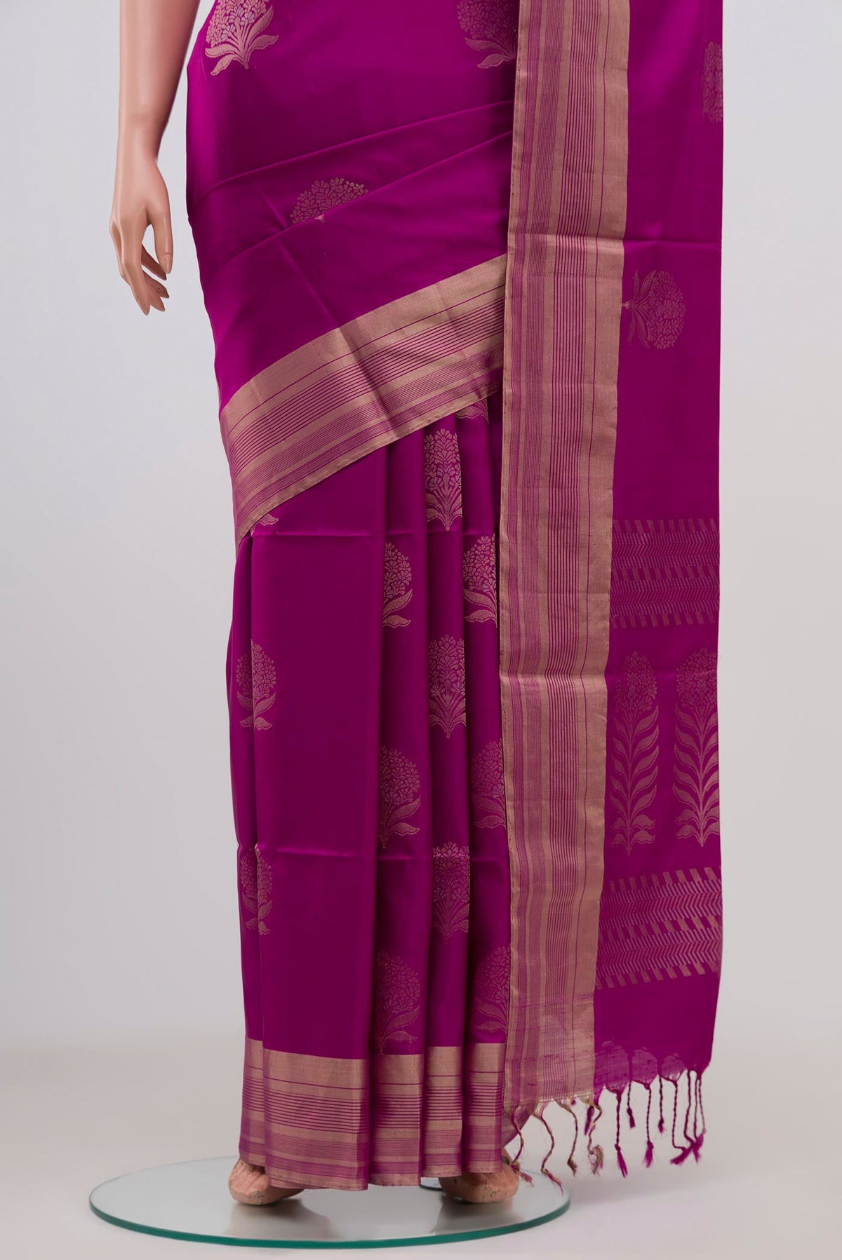 Pleats and pallu of Magenta Soft Silk Saree with Zari Butta on the body and Zari Border. 