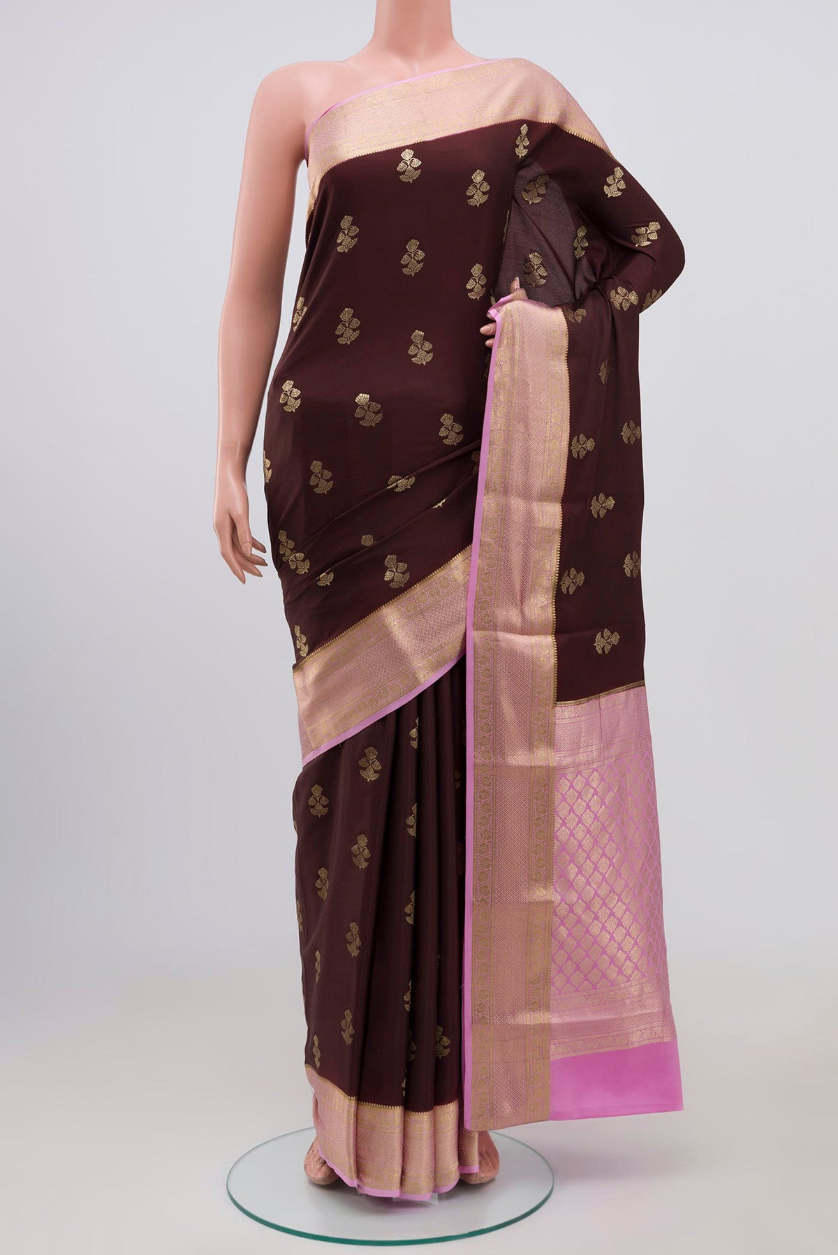 Brown Crepe Saree with Zari Butta on the body and Zari Border.  displayed on a mannequin