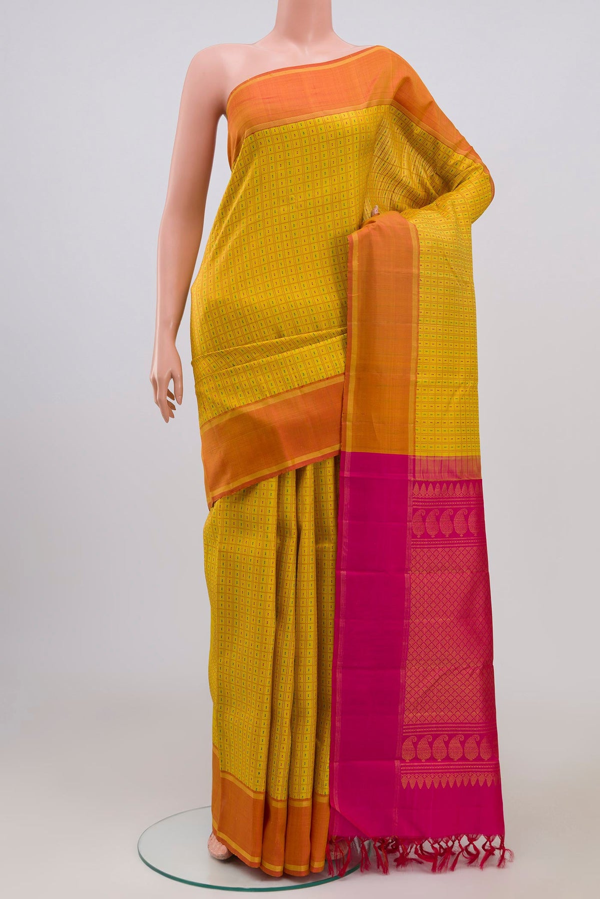 Pure Silk Pure Zari Yellow Kanchipuram Saree with Checked design on the body and Thin Zari Line.  displayed on a mannequin