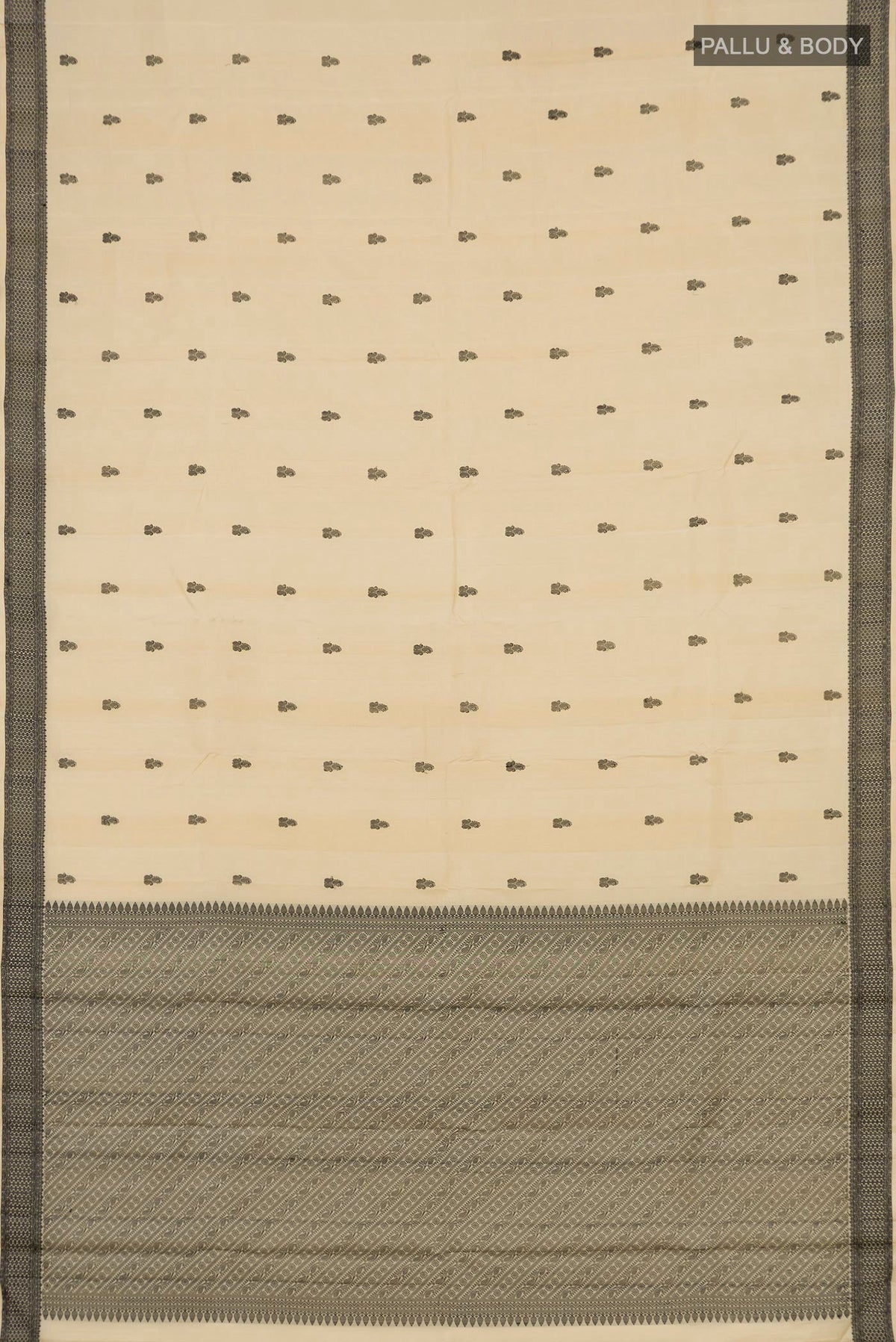 Flat view of Cream Kanchipuram Saree with Thread Butta on the body and Thread Border. 