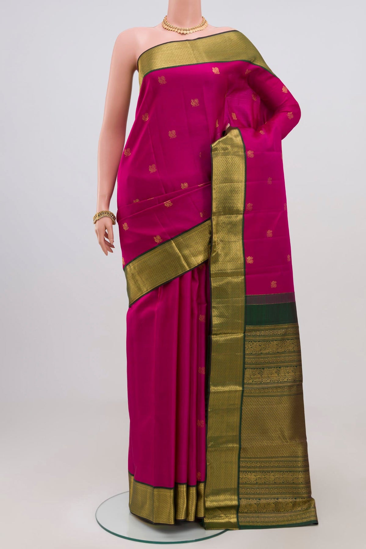 Dark Pink Kanchipuram Silk Saree with Zari Butta on the body and Zari Border.  displayed on a mannequin