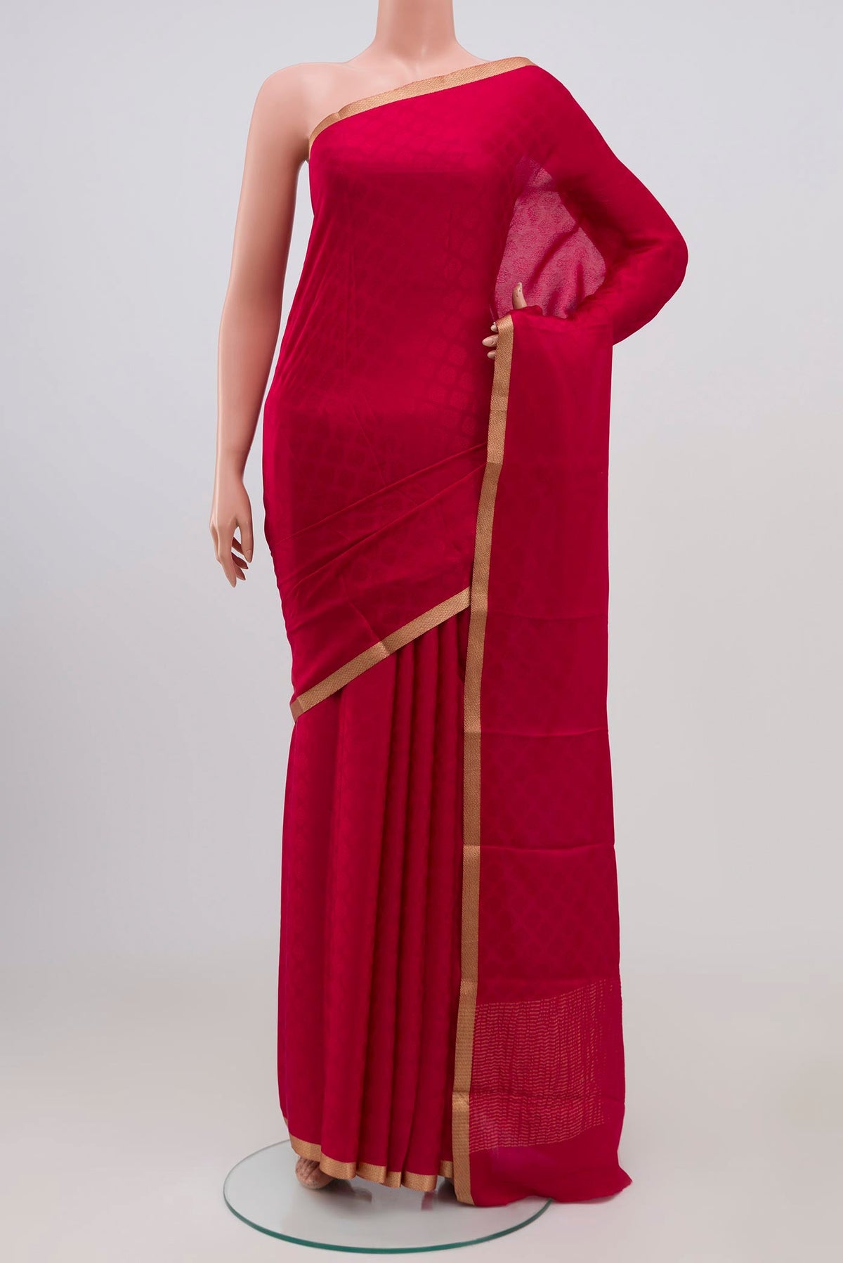Pink Crepe Saree with Jacquard design on the body and Zari Border.  displayed on a mannequin