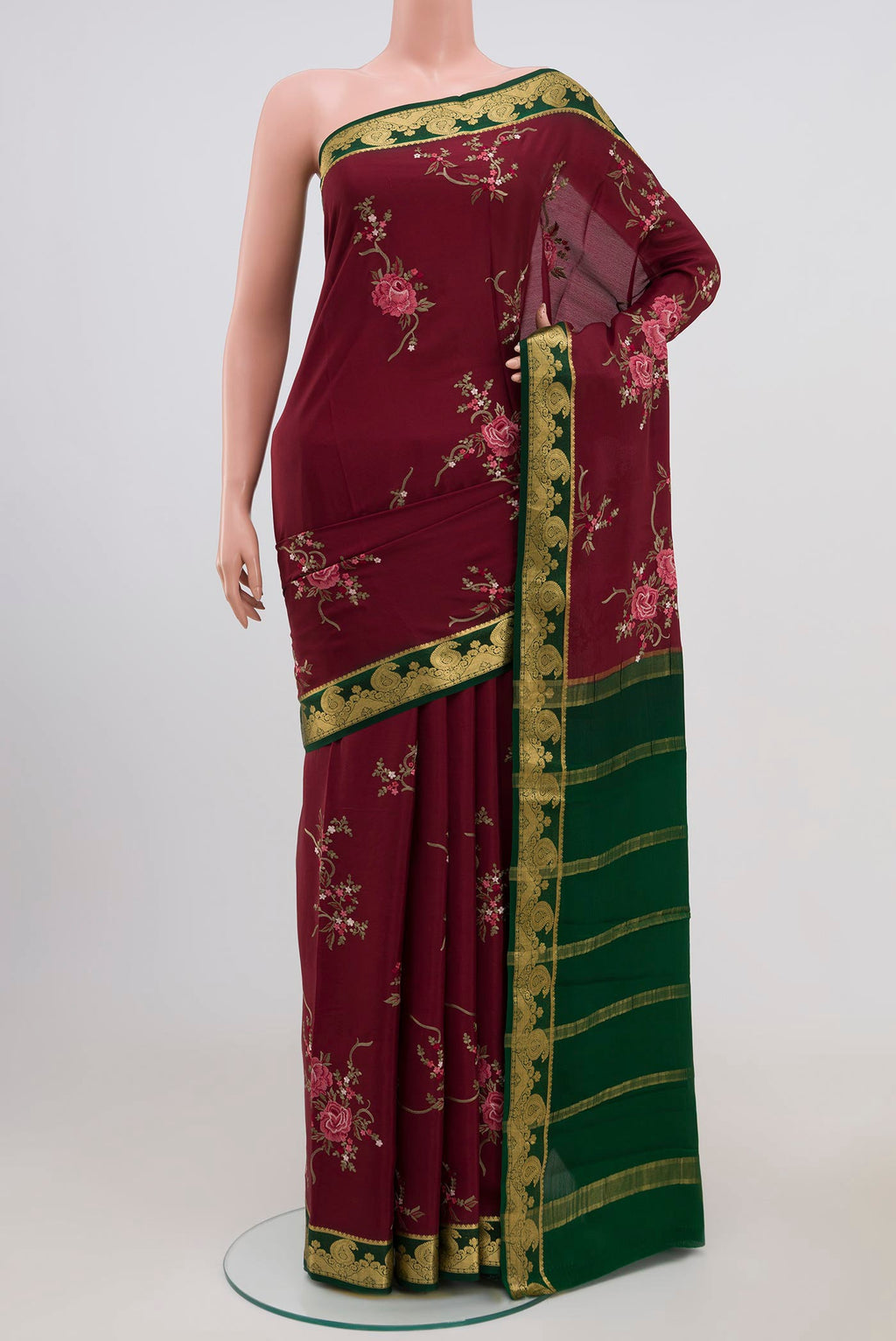 Maroon Mysore Crepe Saree with Fancy on the body and Zari Border.  displayed on a mannequin