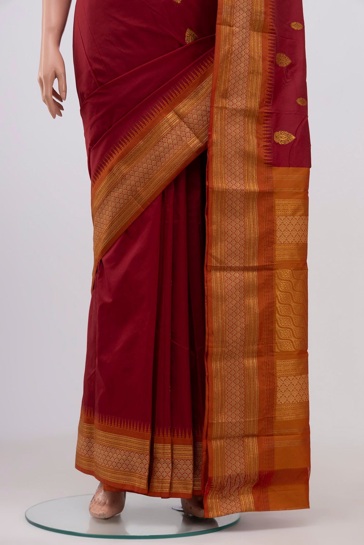 Pleats and pallu of Maroon Blended Bangalore Silk Saree with Zari Butta on the body and Zari Border. 