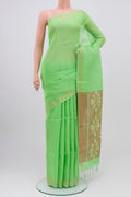 Green Soft Silk Saree with Zari Butta on the body and Zari Border.  displayed on a mannequin
