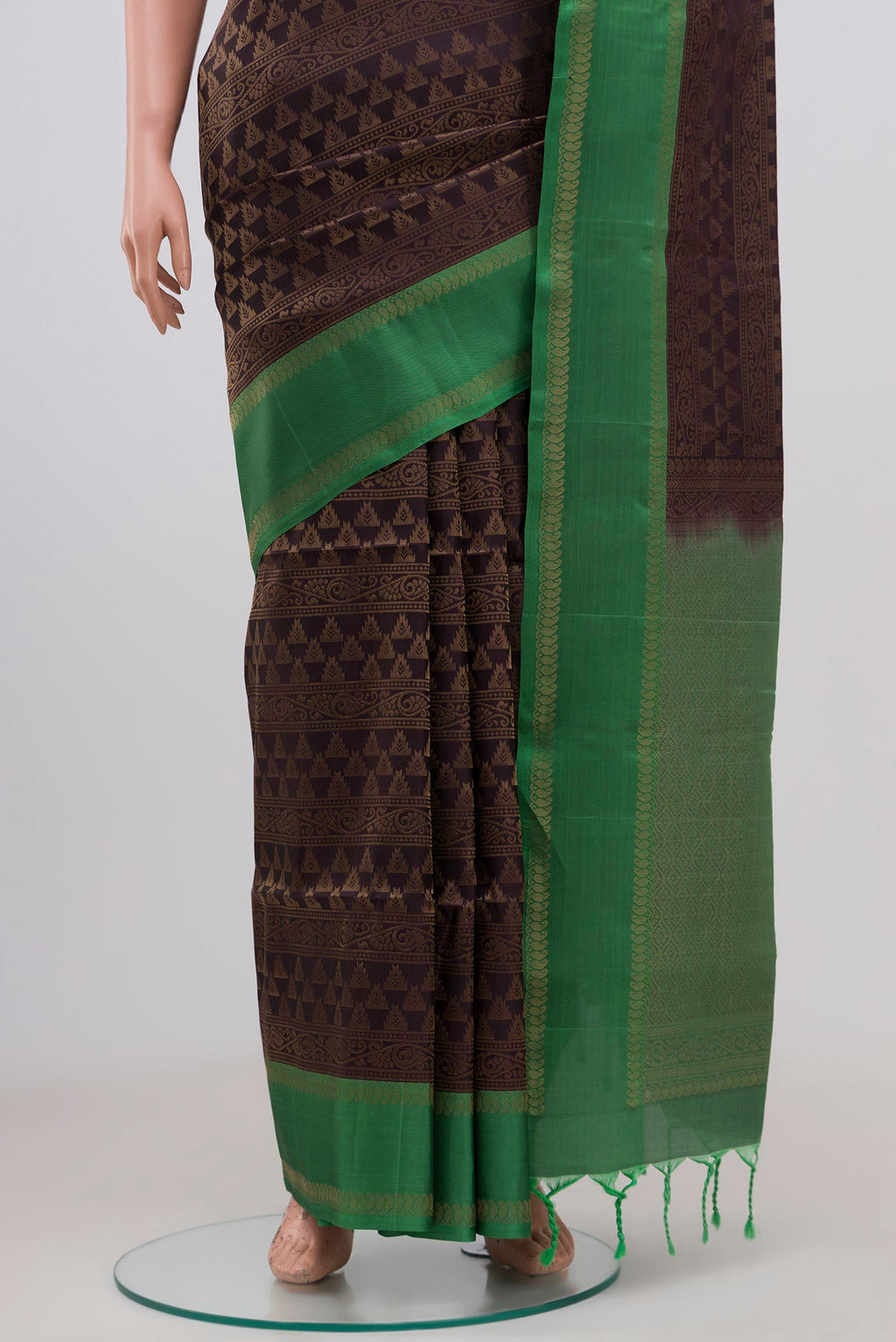 Pleats and pallu of Brown Soft Silk Saree with Zari Brocade on the body and Thin Zari Line. 