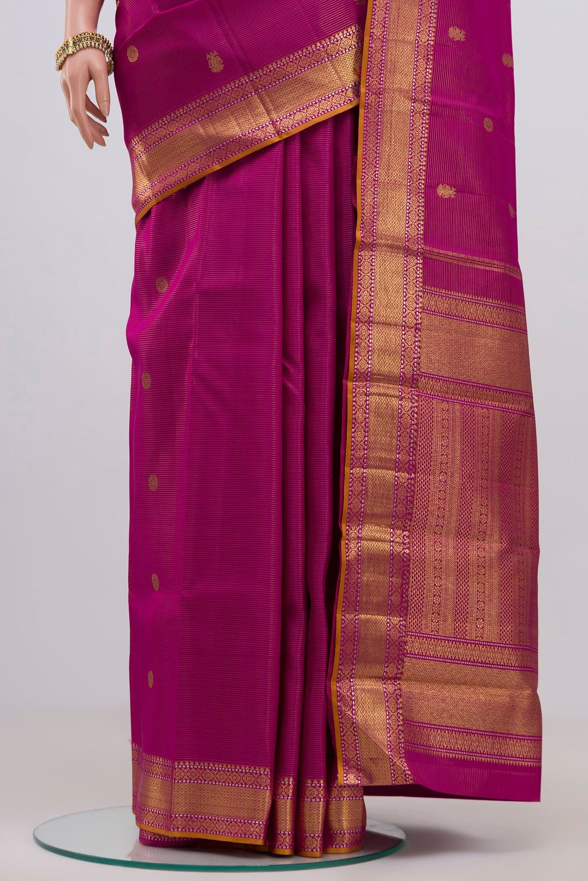 Pleats and pallu of Magenta Kanjivaram Silk Saree with Zari Butta on the body and Zari Border. 