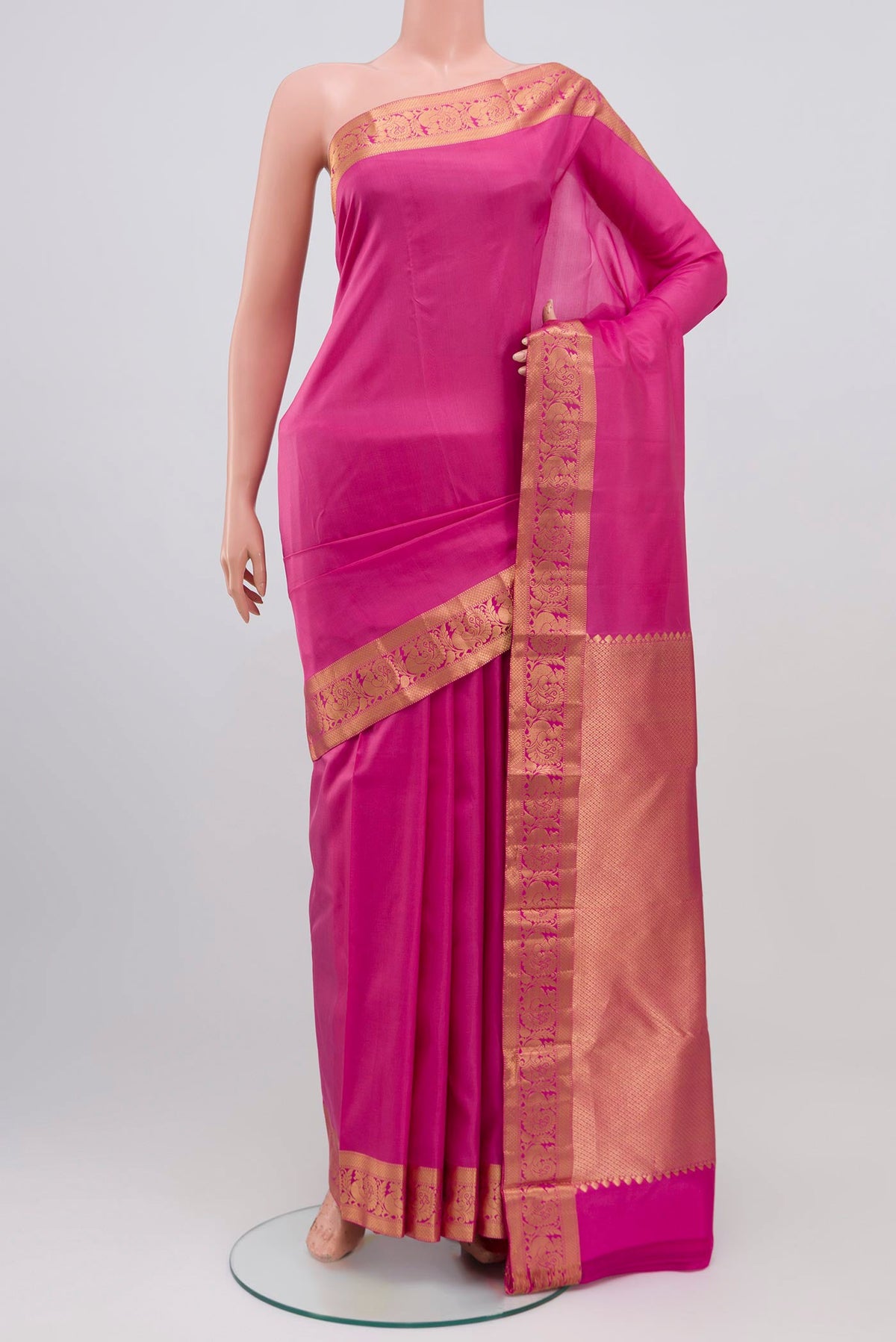 Pink Kanjivaram Saree with Plain Body and Zari Border.  displayed on a mannequin