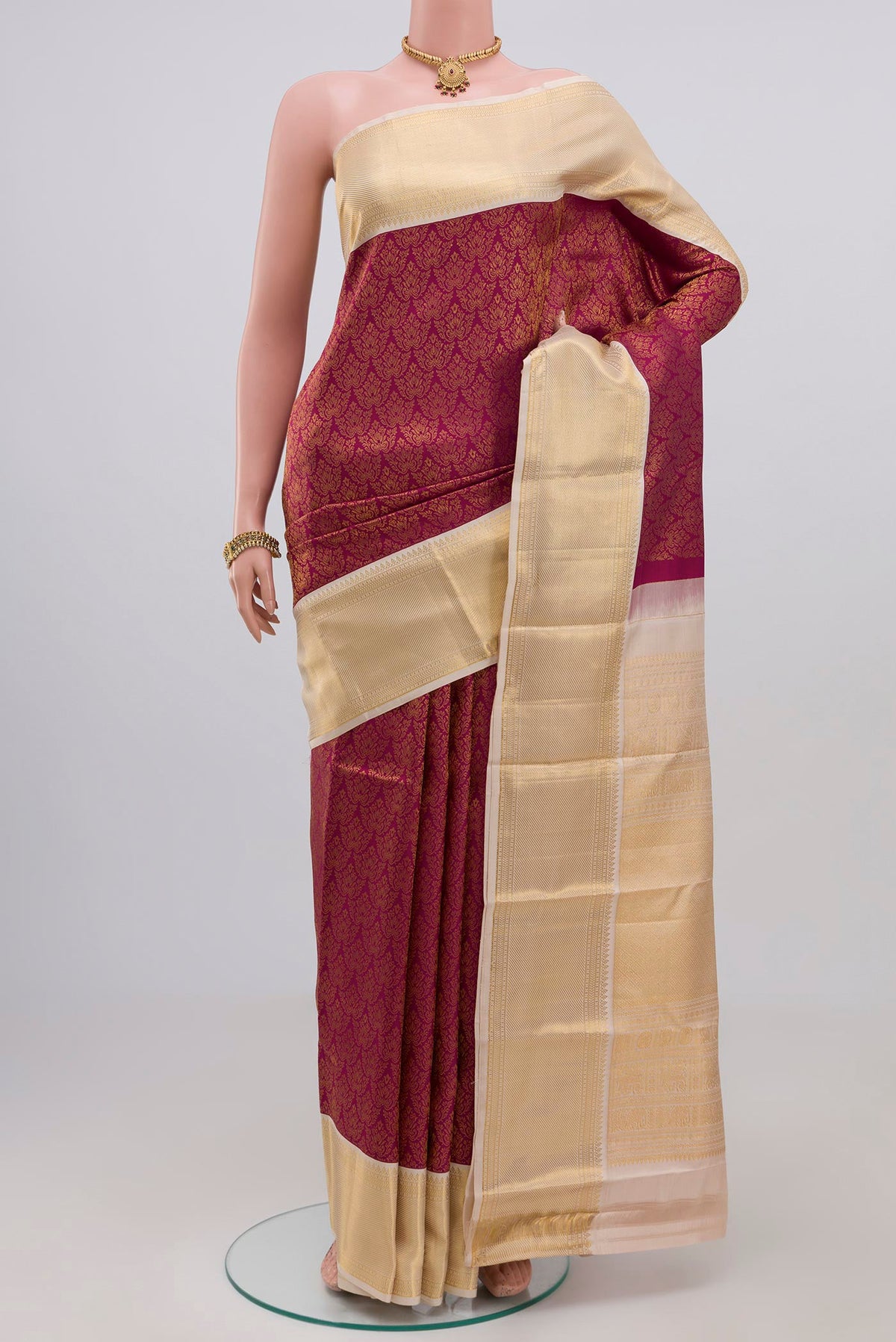 Rani Pink Kanjivaram Silk Saree with Zari Brocade on the body and Zari Border.  displayed on a mannequin
