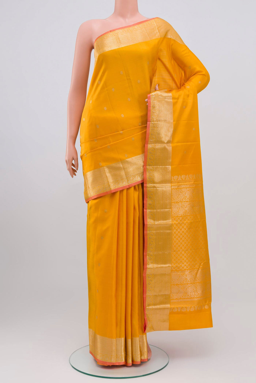 Yellow Kanjivaram Saree with Zari Butta on the body and Zari Border.  displayed on a mannequin