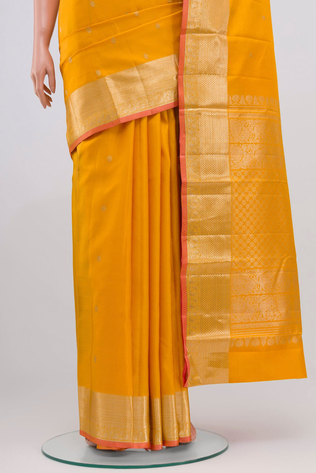 Pleats and pallu of Yellow Kanjivaram Saree with Zari Butta on the body and Zari Border. 