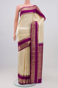 Cream Kanchipuram Silk Saree with Zari Brocade on the body and Zari Border.  displayed on a mannequin