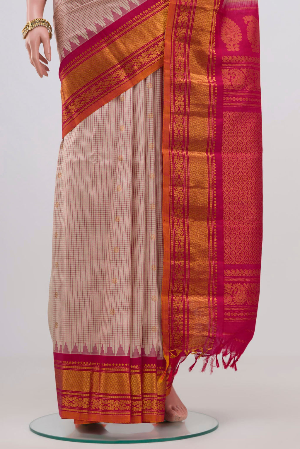 Pleats and pallu of Cream Gadwal Silk Saree with Checked design on the body and Zari Border. 