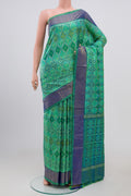 Light Green Pochampally Silk Saree with Ikat Print on the body and Zari Border.  displayed on a mannequin