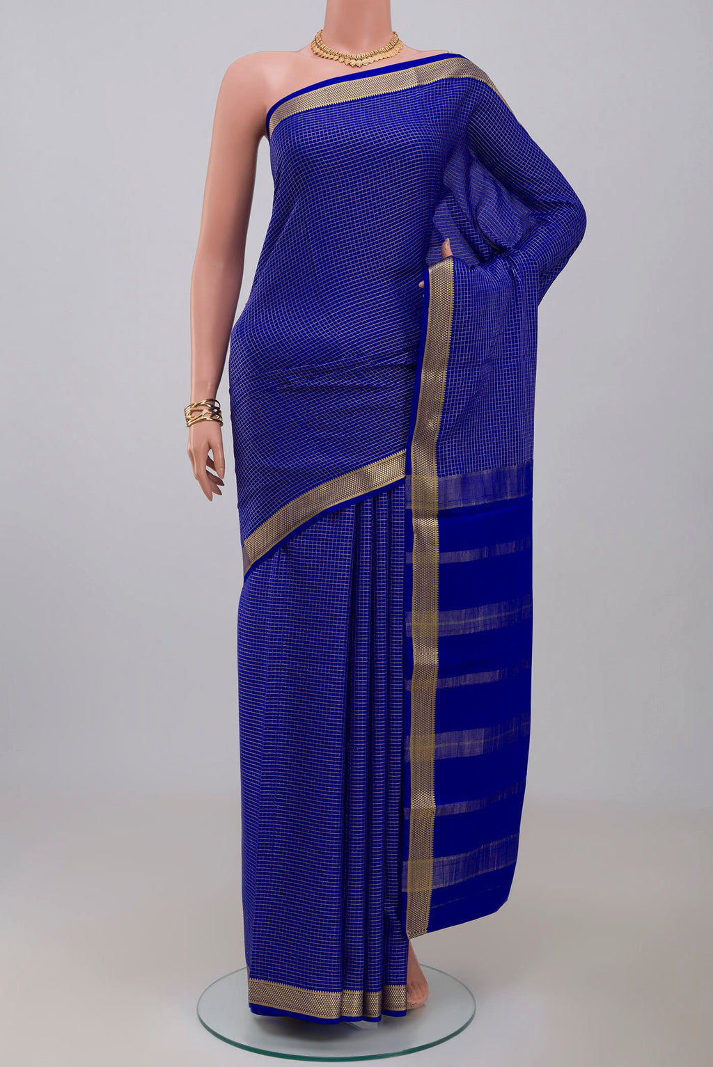 Blue Crepe Saree with Checked design on the body and Zari Border.  displayed on a mannequin