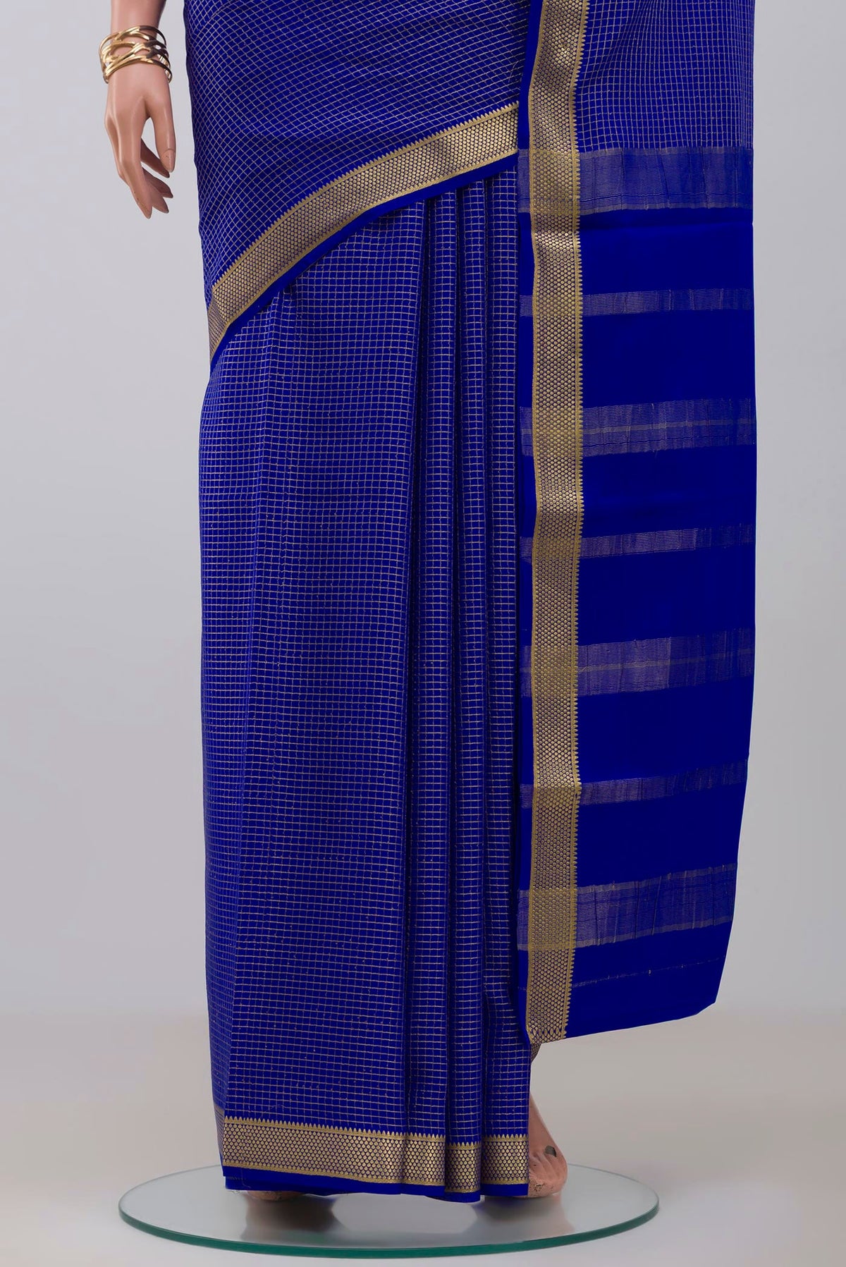 Pleats and pallu of Blue Crepe Saree with Checked design on the body and Zari Border. 