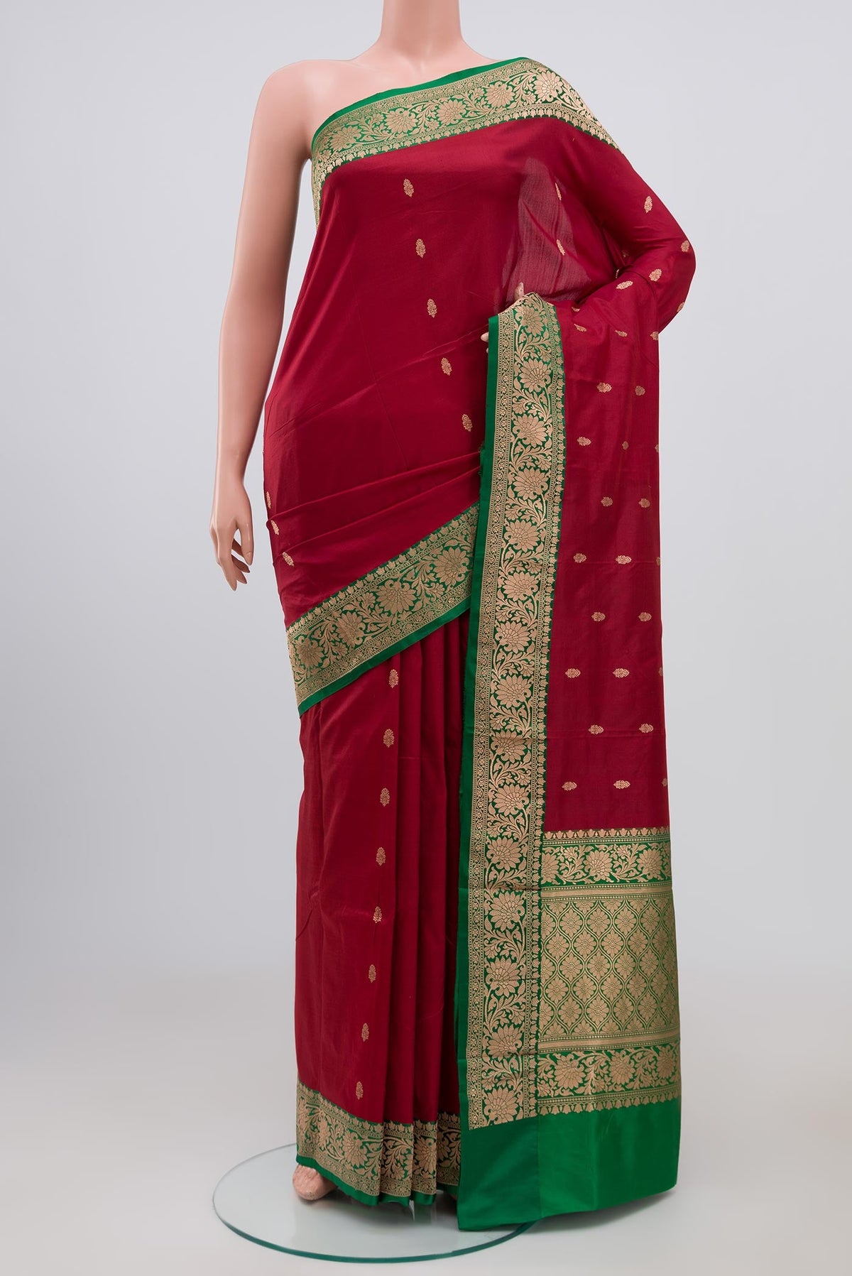 Maroon Banarasi Katan Silk Saree with Zari Butta on the body and Zari Border.  displayed on a mannequin