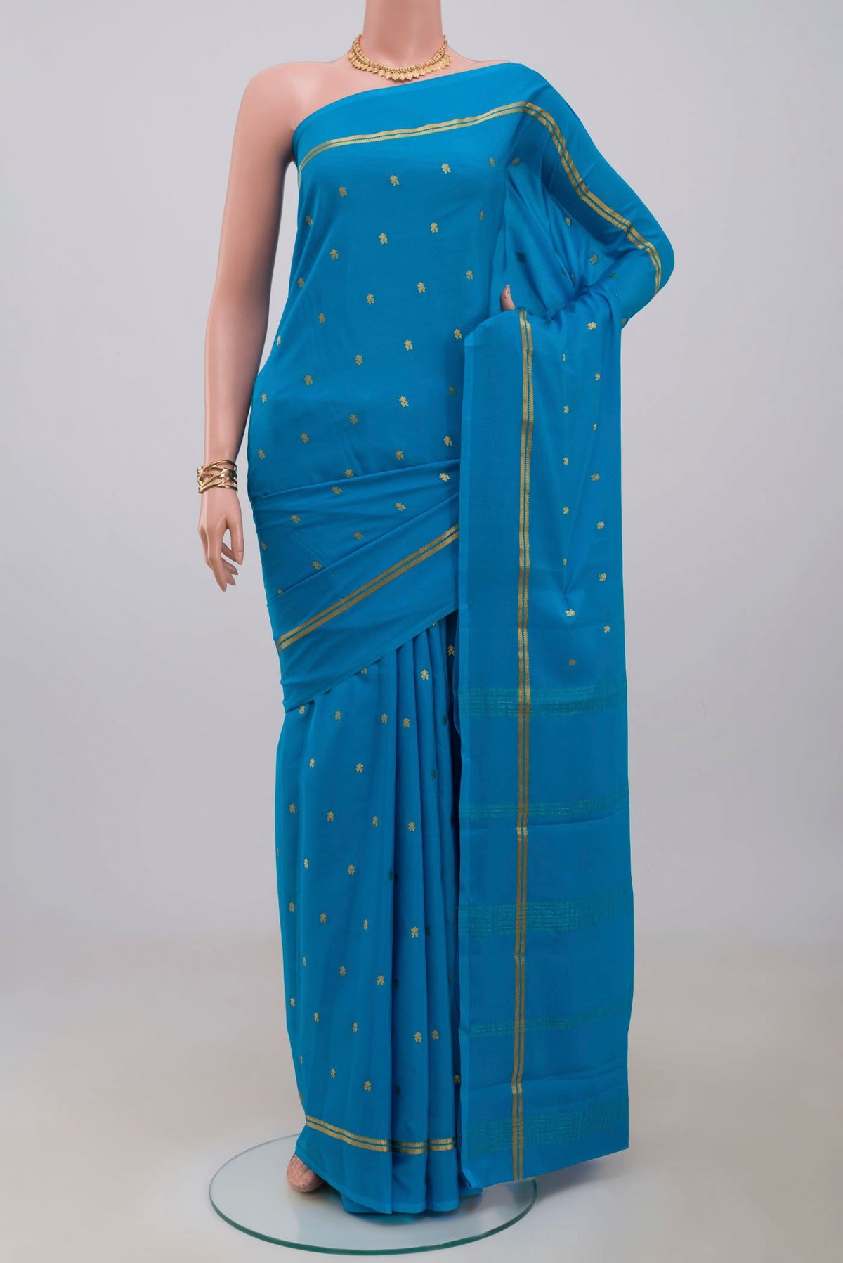 Blue Mysore Crepe Saree with Zari Butta on the body and Plain Border.  displayed on a mannequin