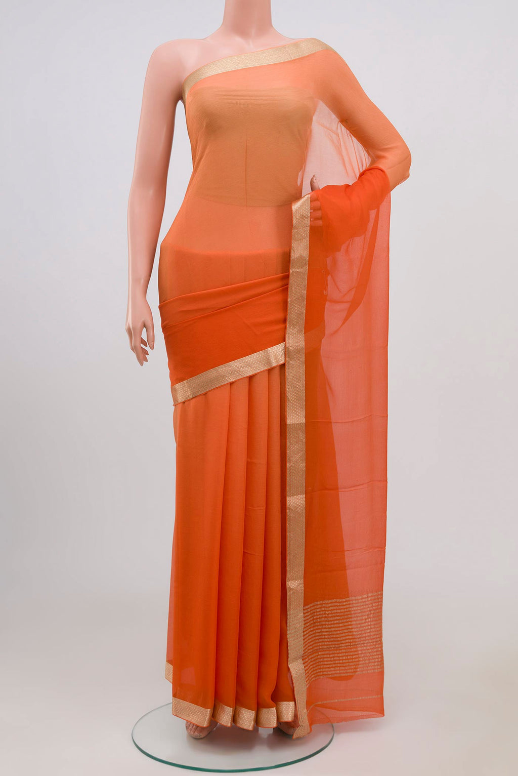Orange Chiffon Saree with Plain Body and Zari Border.  displayed on a mannequin