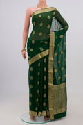 Green Georgette Saree with Fancy on the body and Zari Border.  displayed on a mannequin