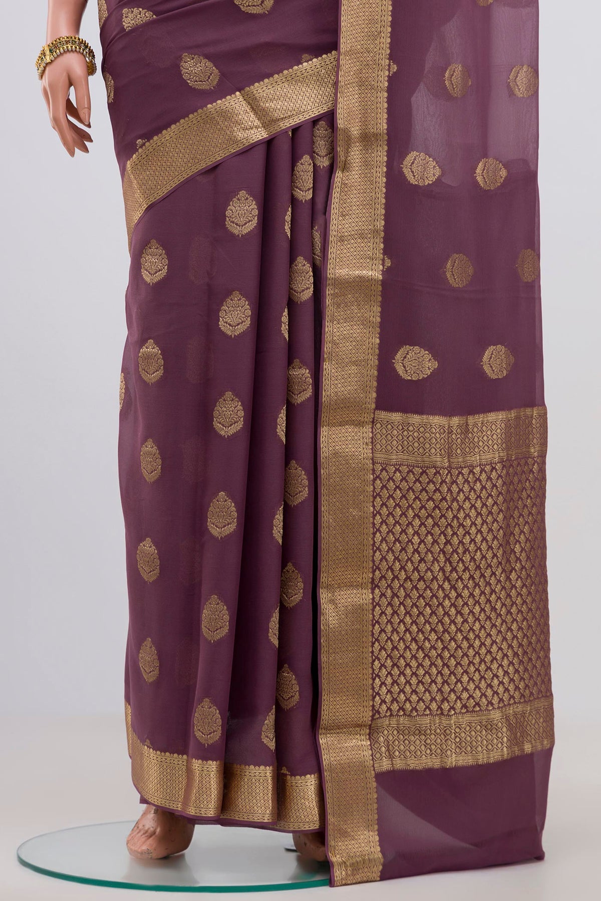 Pleats and pallu of Lavender Georgette Saree with Fancy on the body and Zari Border. 