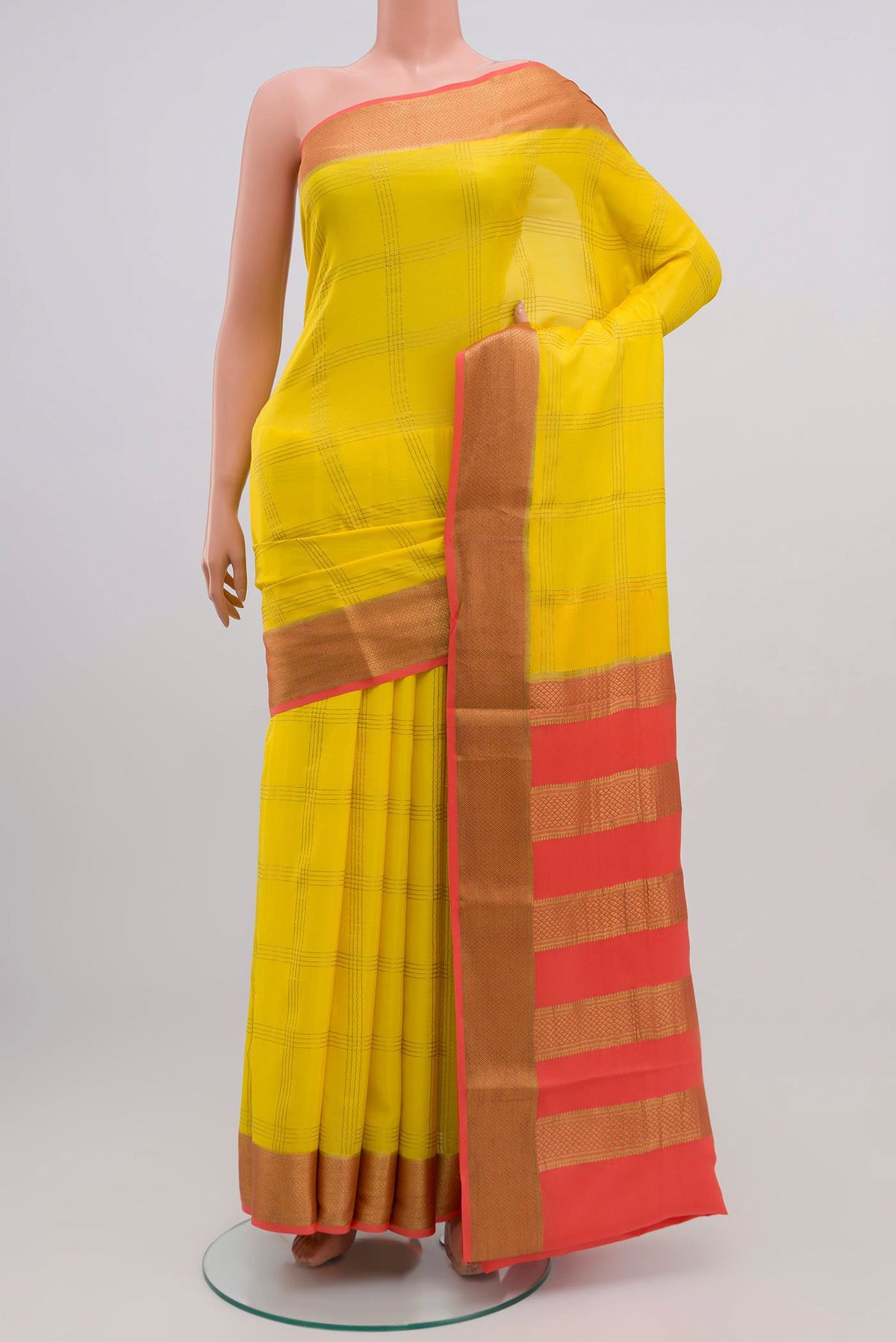 Yellow Crepe Saree with Checked design on the body and Zari Border.  displayed on a mannequin