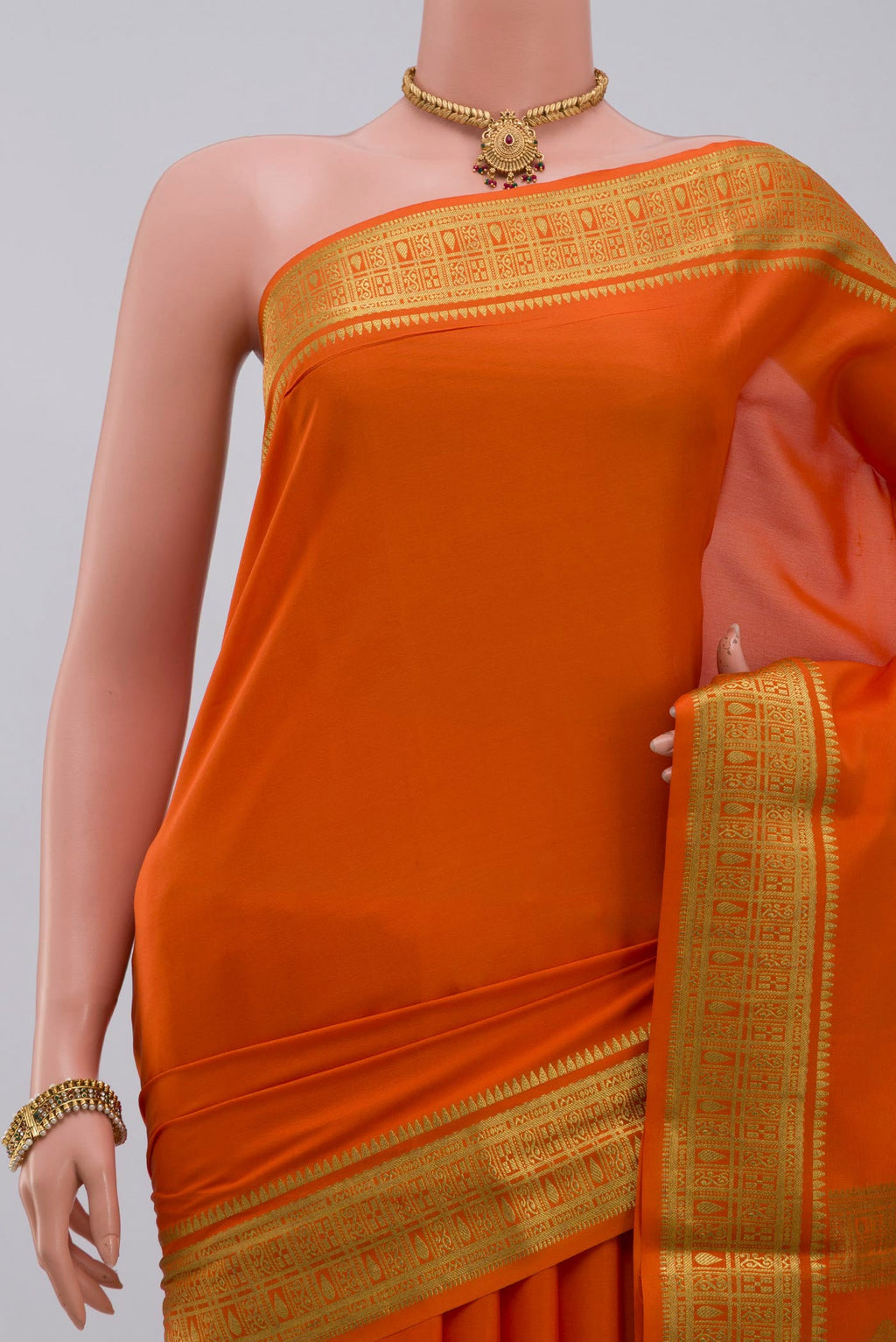 Border image of Orange Crepe Saree with Plain Body and Zari Border. 