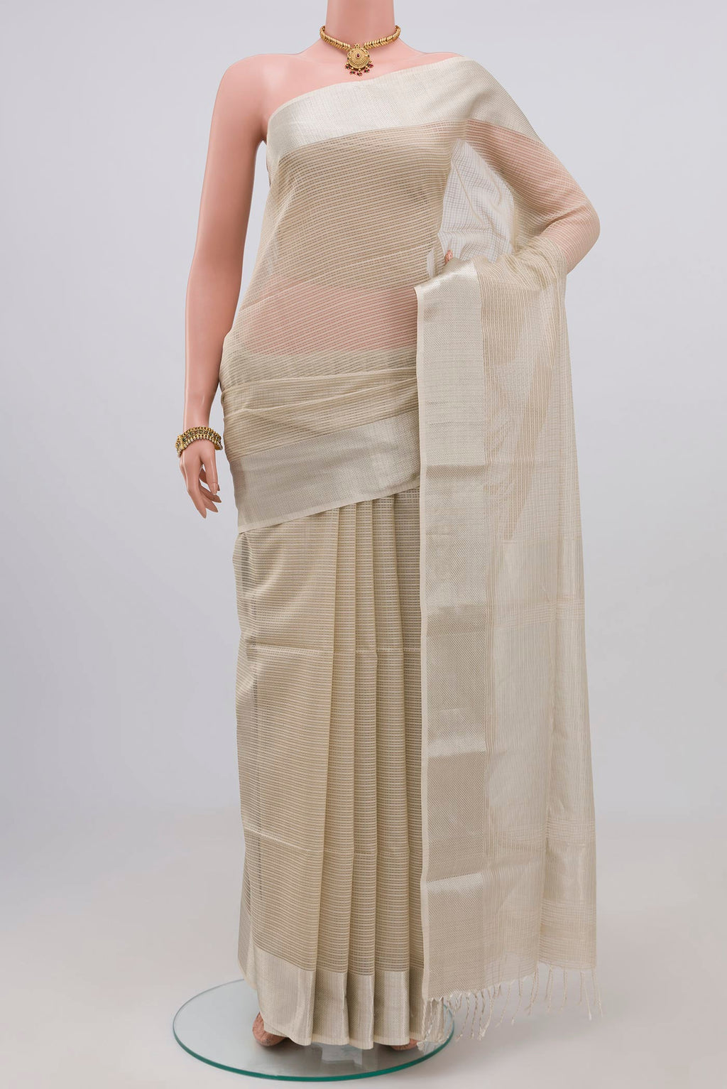 White Maheshwari Silk Cotton Saree with Checked design on the body and Zari Border.  displayed on a mannequin