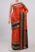 Orange Pochampally Silk Saree with Ikat Print on the body and Zari Border.  displayed on a mannequin
