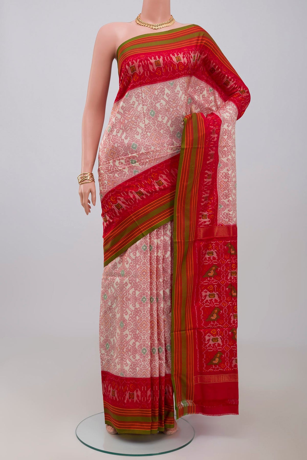 Peach Pochampally Silk Saree with Ikat design on the body and Plain Border.  displayed on a mannequin