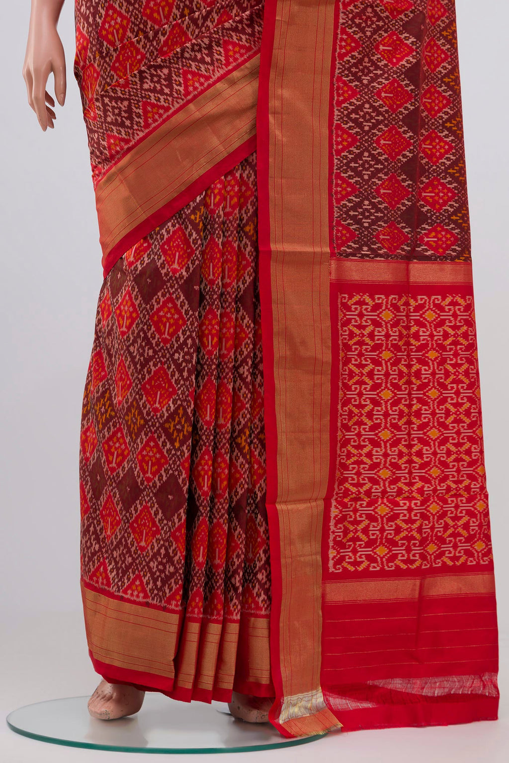 Pleats and pallu of Orange Pochampally Silk Saree with Ikat design on the body and Zari Border. 