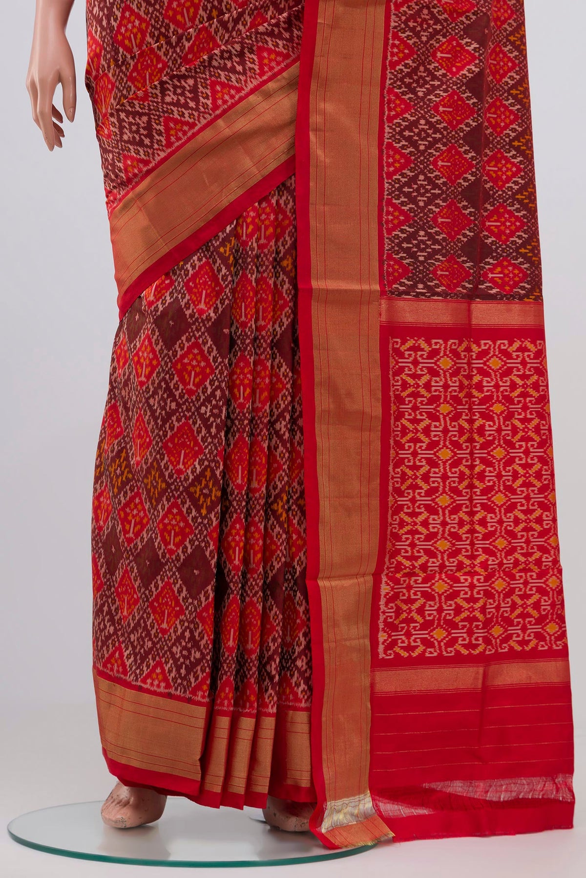 Pleats and pallu of Orange Pochampally Silk Saree with Ikat design on the body and Zari Border. 