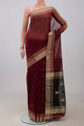 Maroon Chanderi Silk Cotton Saree with Zari Butta on the body and Zari Border.  displayed on a mannequin