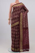 Brown Pochampally Silk Saree with Ikat Print on the body and Zari Border.  displayed on a mannequin