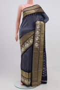 Grey Pochampally Silk Saree with Ikat design on the body and Zari Border.  displayed on a mannequin