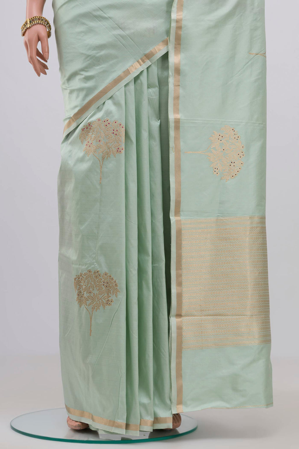 Pleats and pallu of Light Green Banarasi Katan Silk Saree with Zari Butta on the body and Thin Zari Line. 