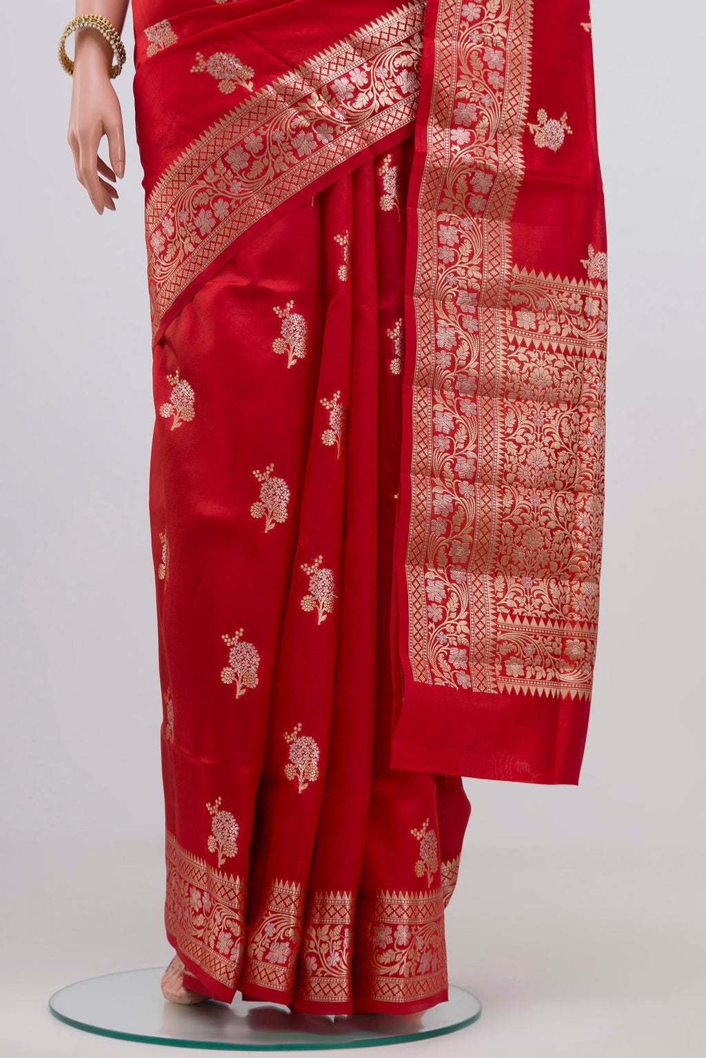 Pleats and pallu of Red Raw Silk Saree with Zari Butta on the body and Zari Border. 