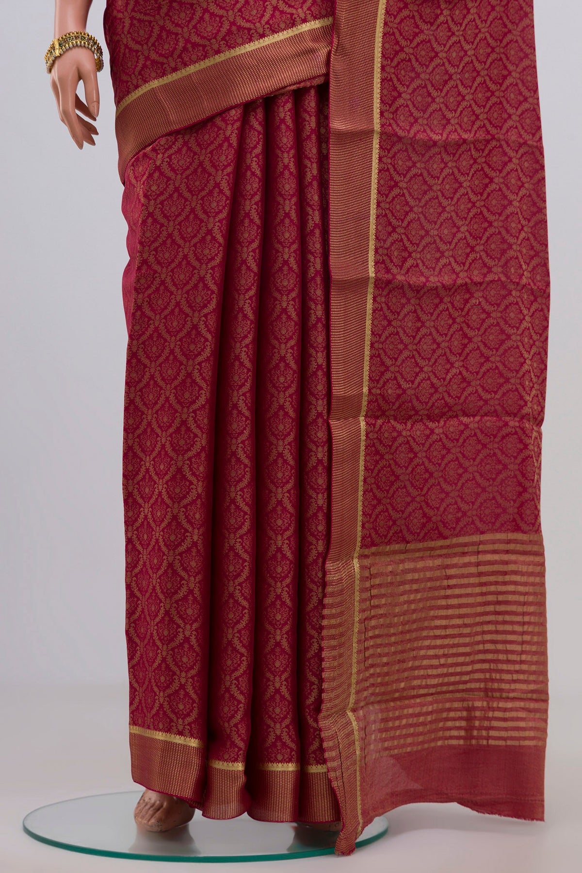 Pleats and pallu of Pink Georgette Saree with Zari Brocade on the body and Zari Border. 